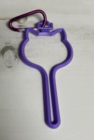 Hands free poop holder/waste bag holder dog head shape