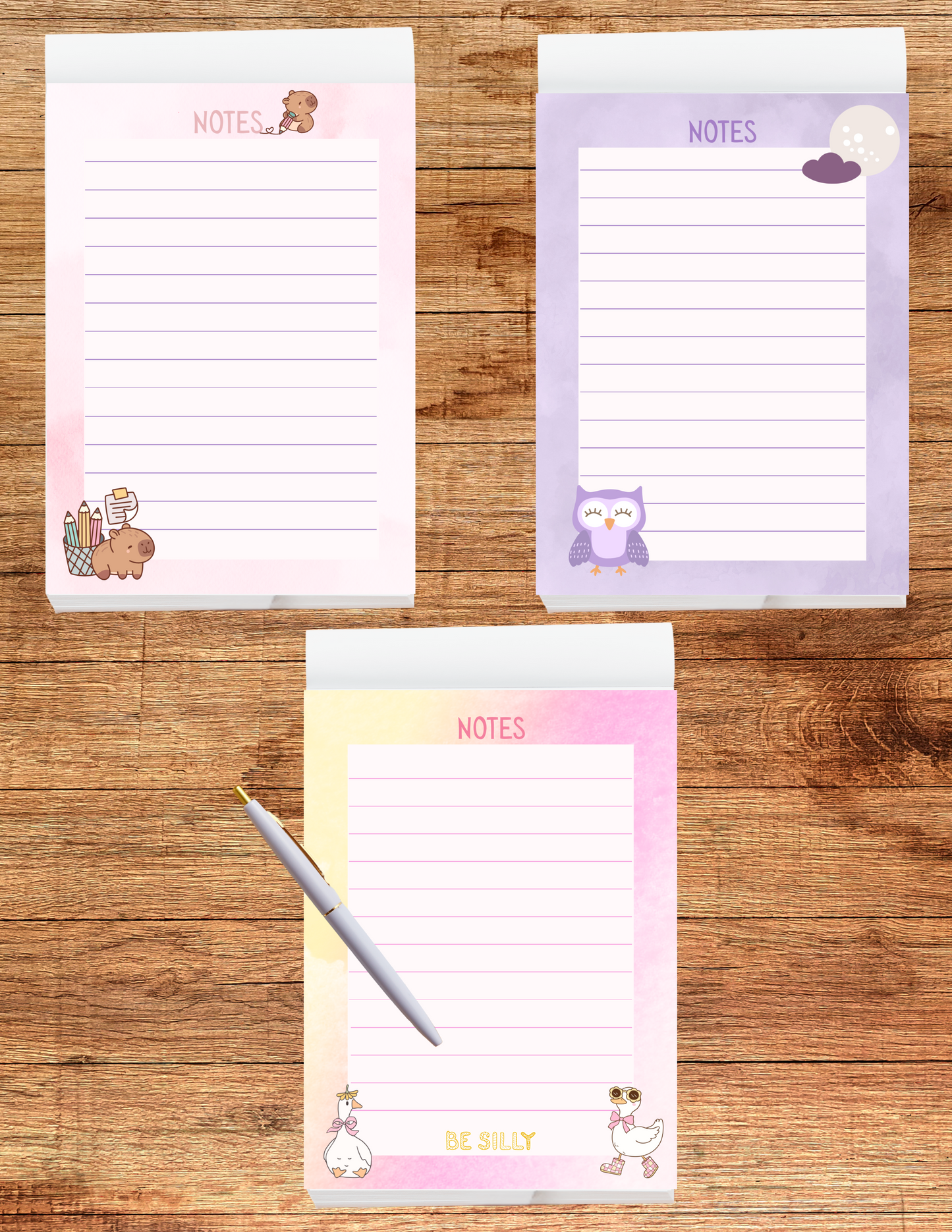 Three colorful notepads with animal illustrations on a wooden surface
