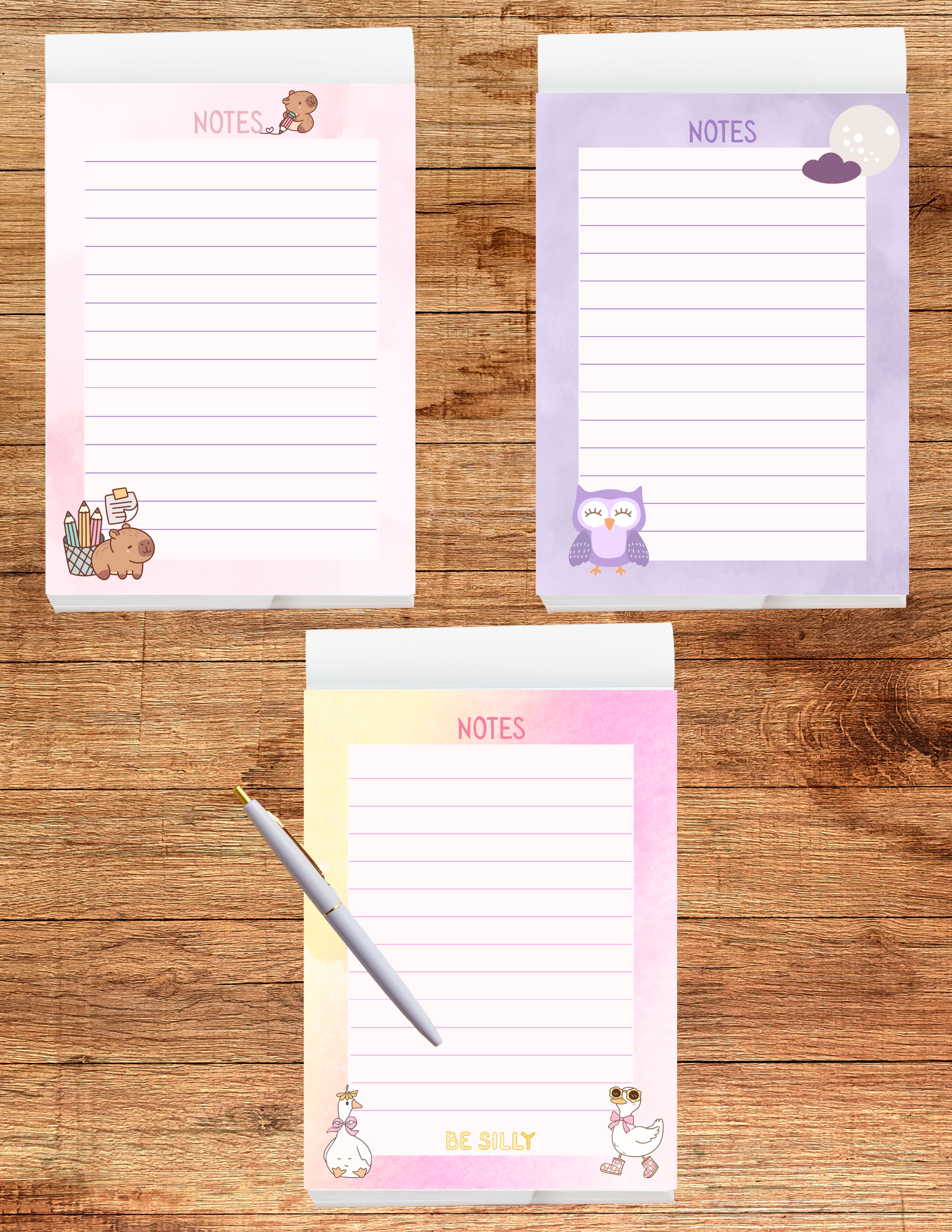 Three colorful notepads with animal illustrations on a wooden surface