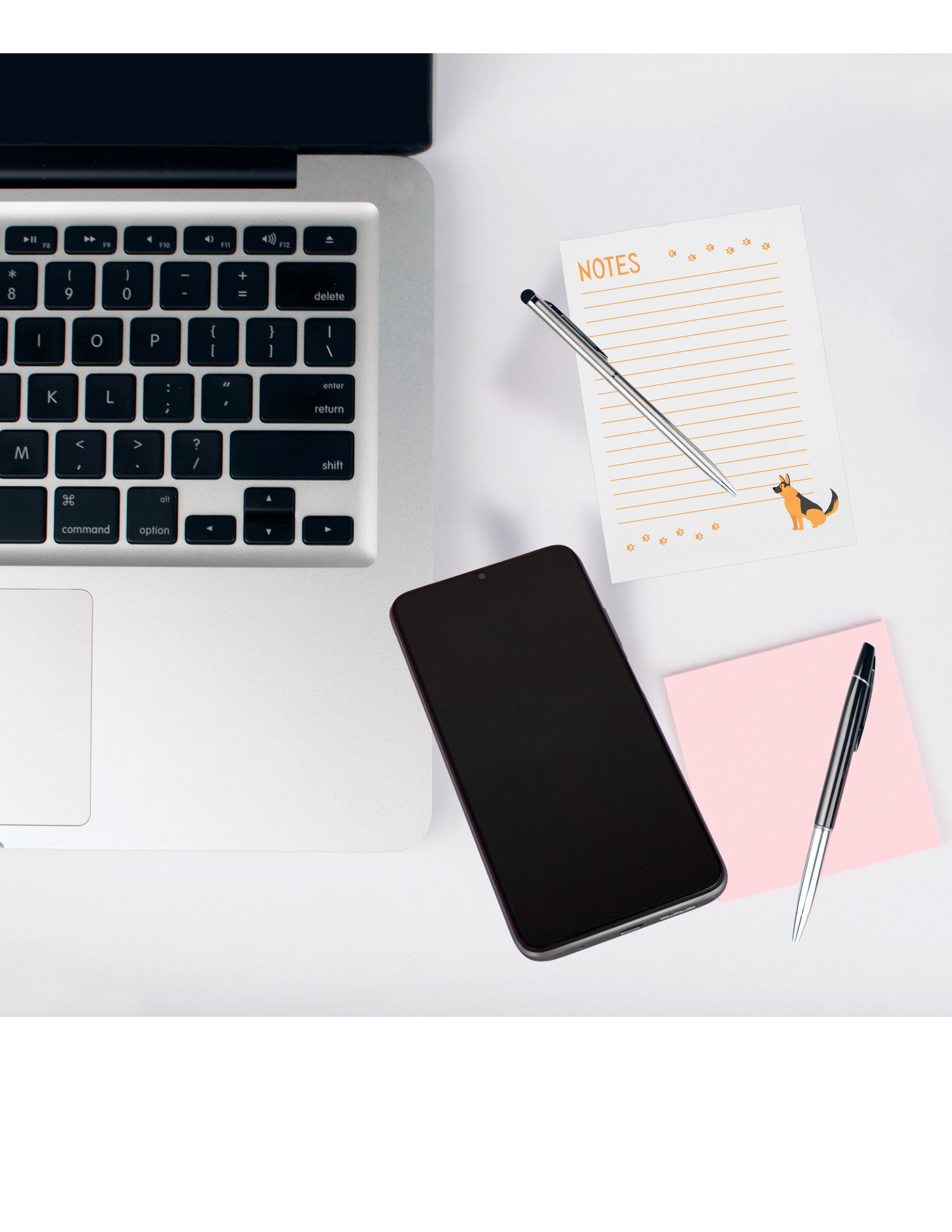 Laptop, smartphone, notepad with pen, and pink notepad with pen on a white surface