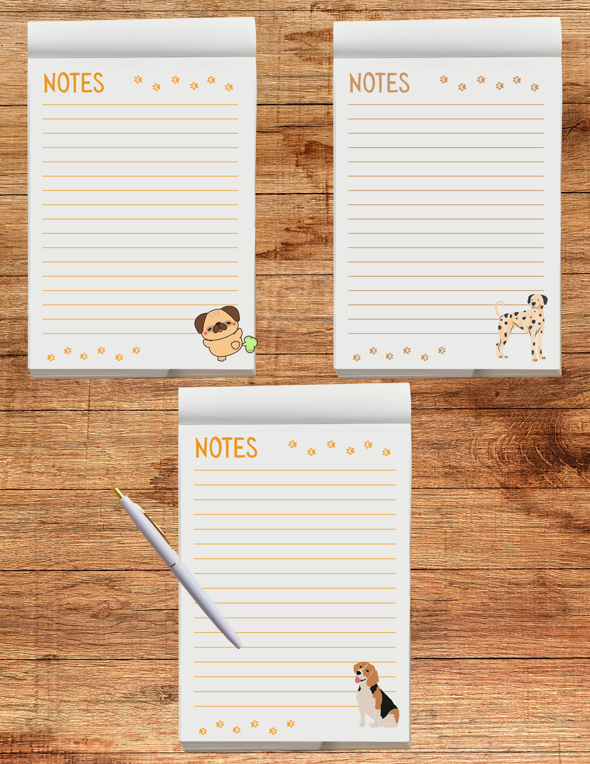 Three notepads with dog illustrations on a wooden surface