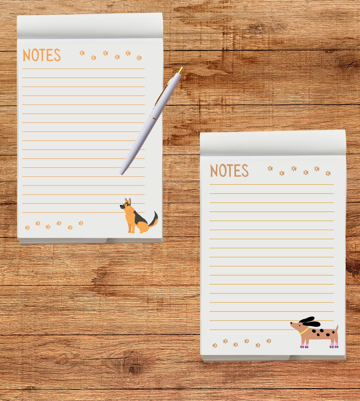 Two notepads with dog illustrations on a wooden surface