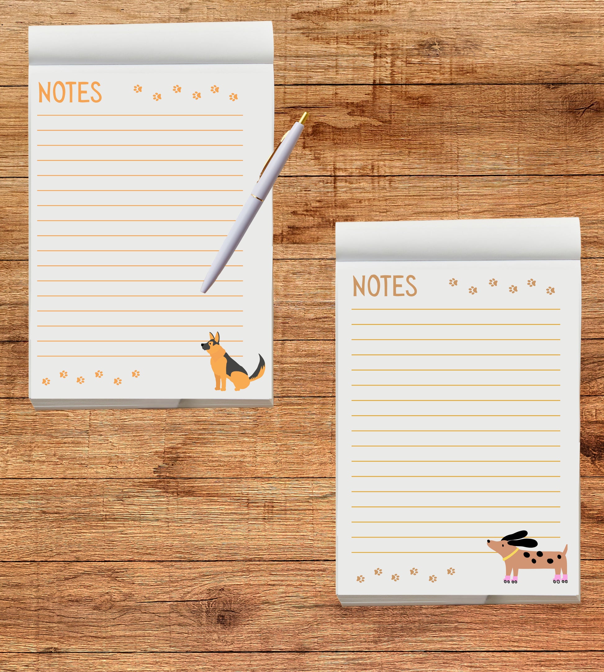Two notepads with dog illustrations on a wooden surface