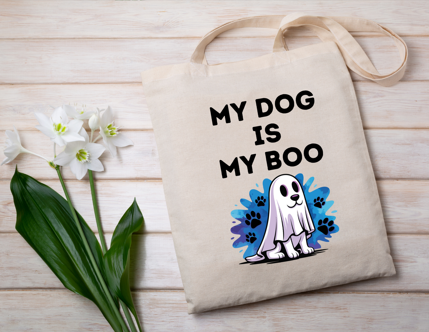 Tote bag with 'My Dog is My Boo' design on a wooden surface with flowers.