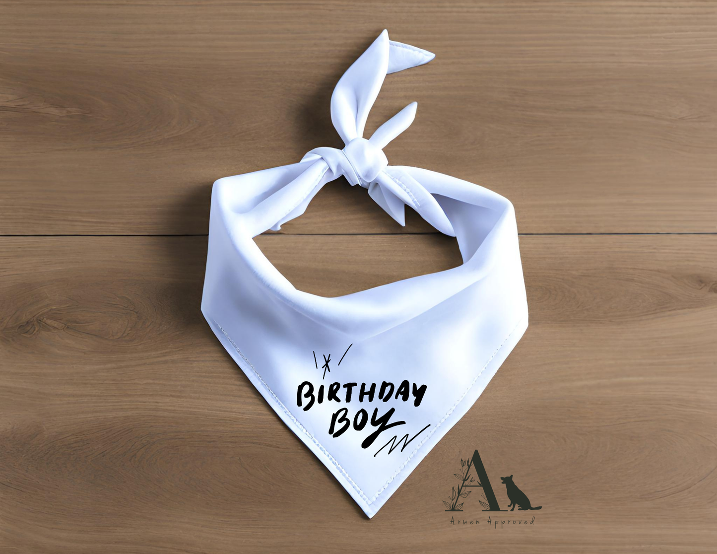 White bandana with 'Birthday Boy' text on a wooden surface