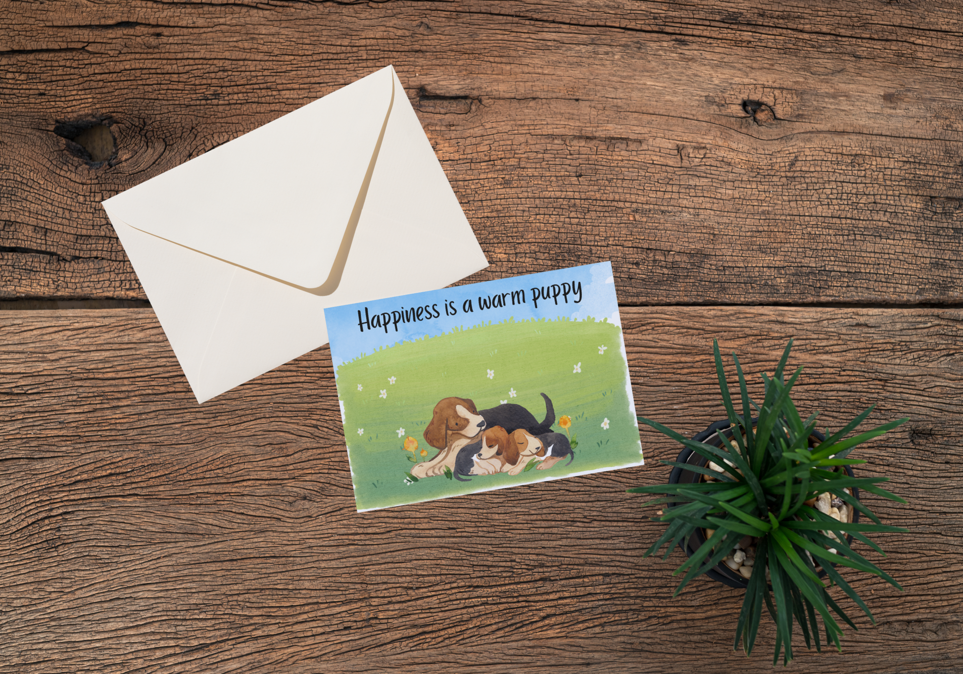 greeting card with puppies laying in grass and the text happiness is a warm puppy