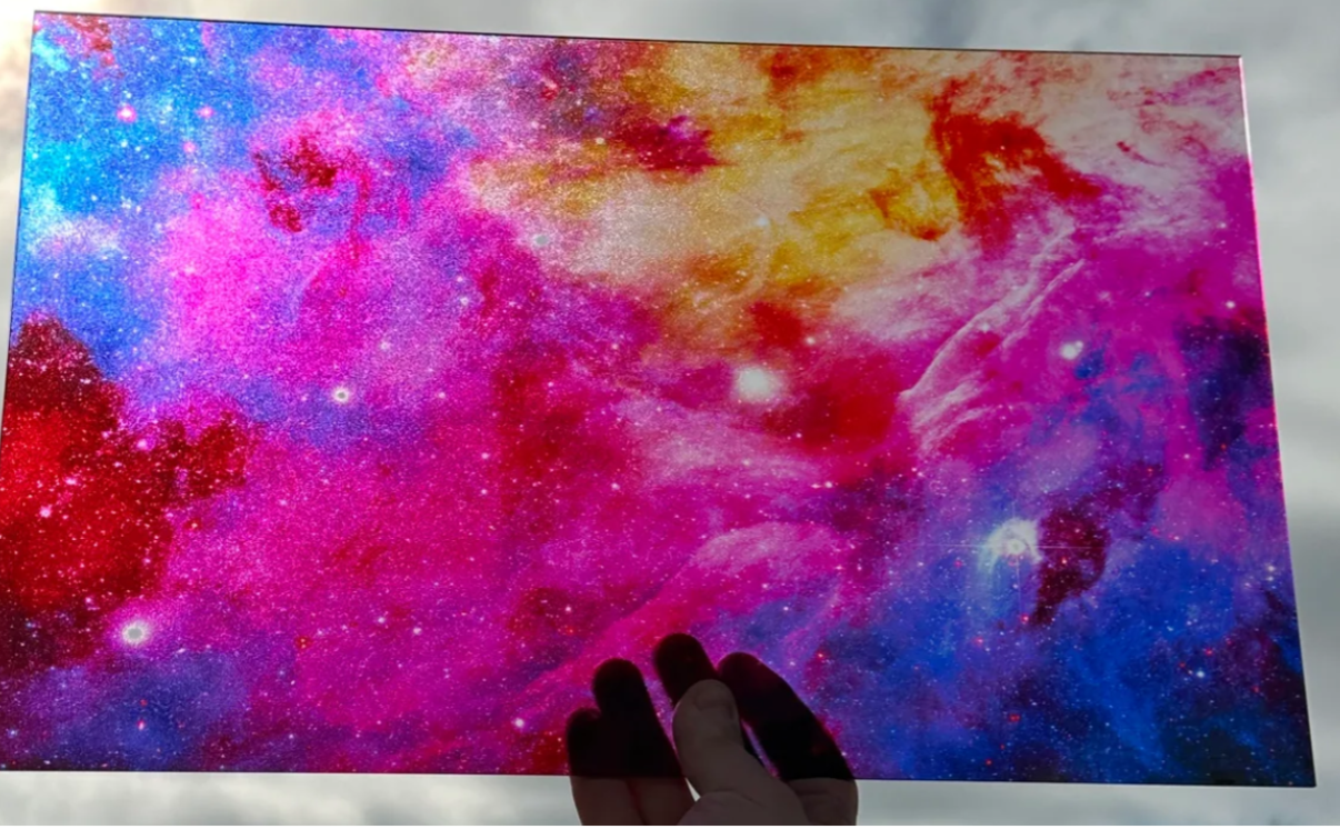 Colorful abstract galaxy backing with a hand holding it
