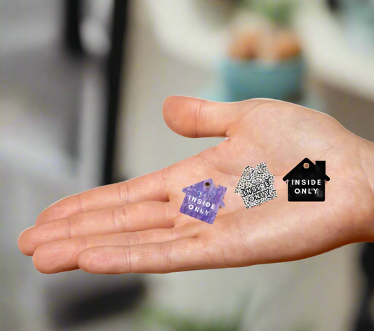 Hand holding collar charms