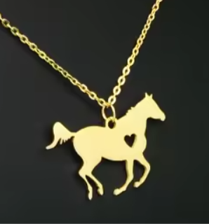 Gold horse-shaped pendant on a chain against a black background