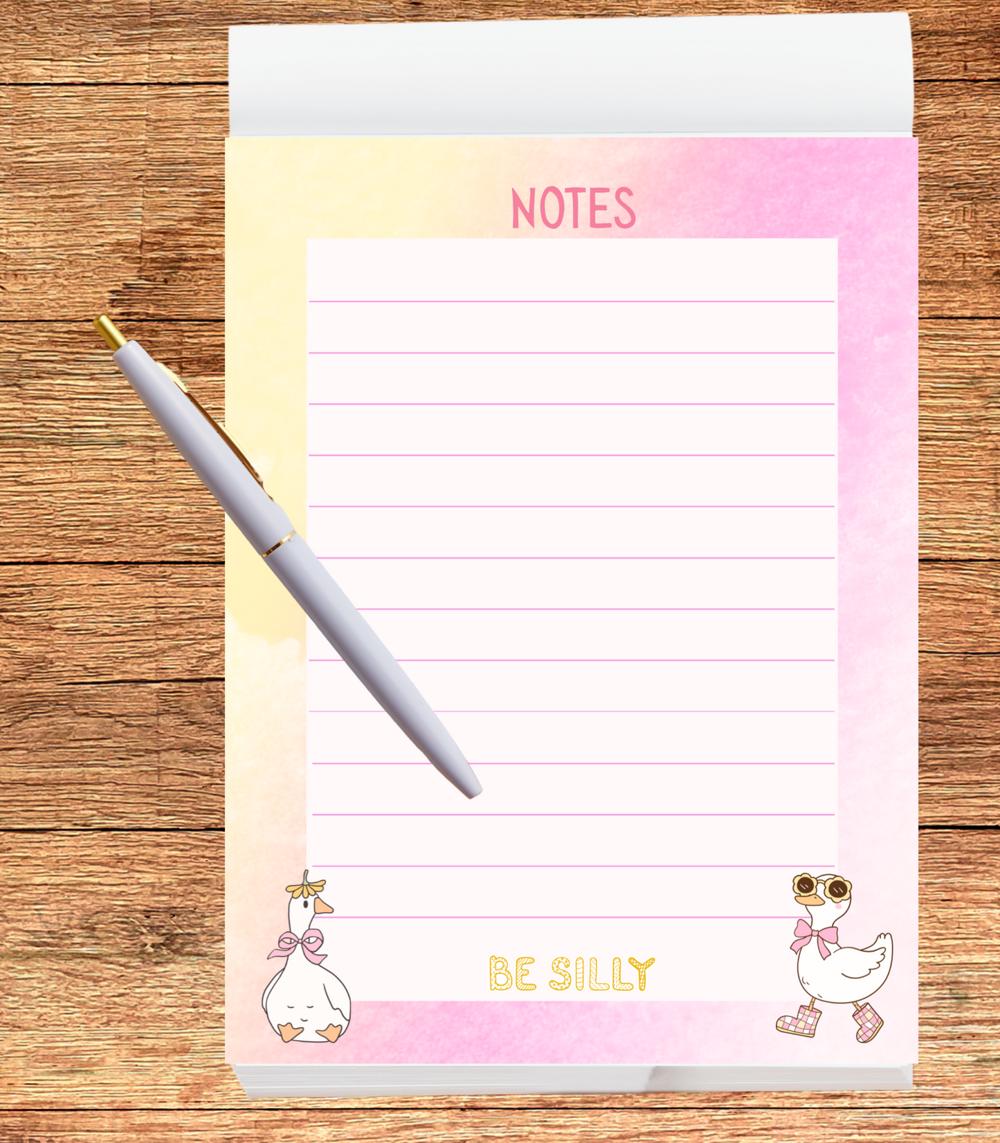 Notepad with silly geese and text on a wooden surface