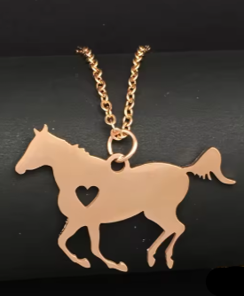 Rose gold horse-shaped pendant with a heart on a black background