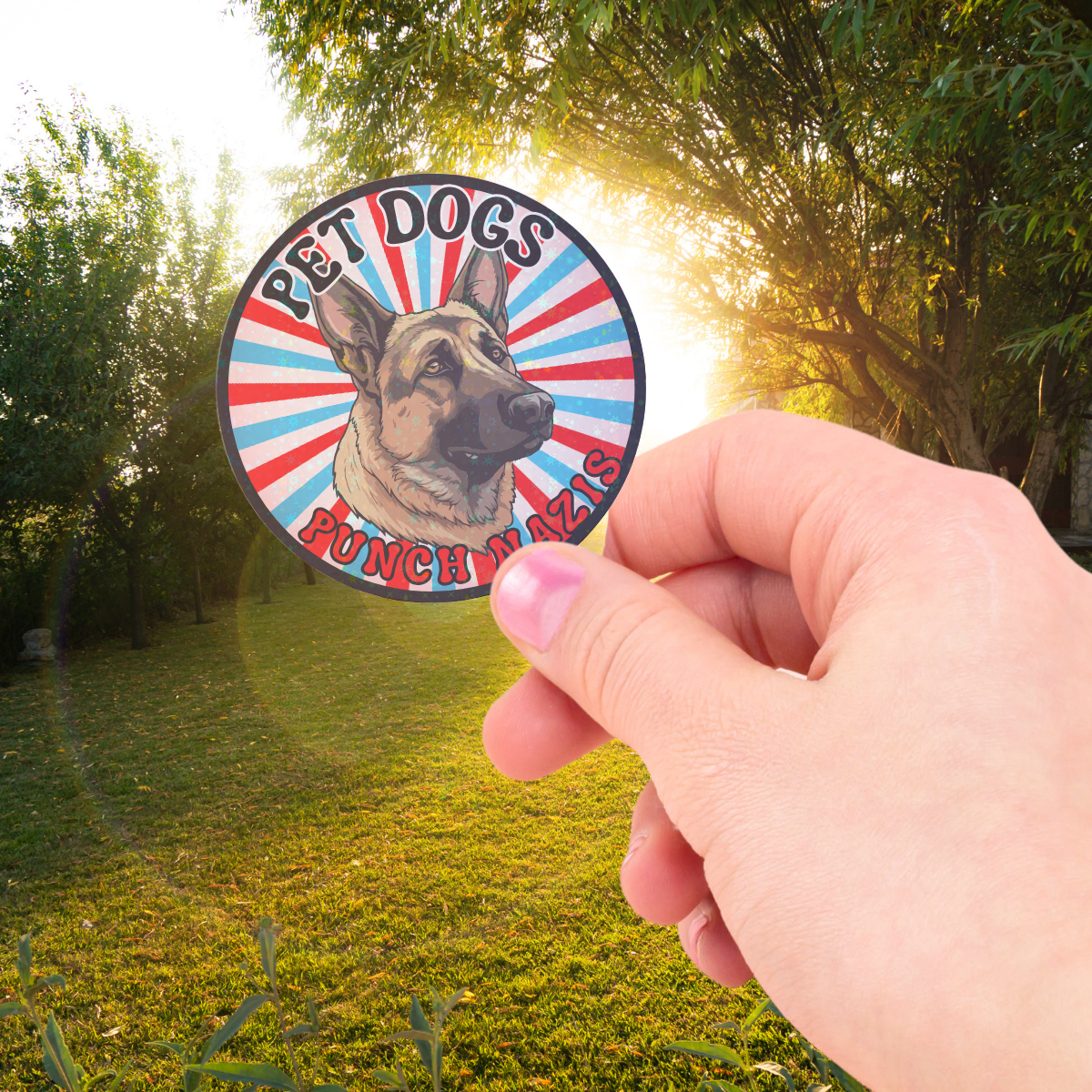 Person holding a sticker of a german shepherd dog that says pet dogs punch nazis