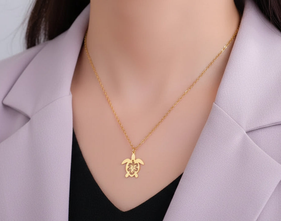 Gold turtle pendant necklace on a woman