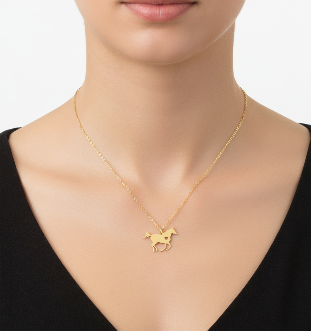 Gold necklace with a horse pendant on a model against a neutral background