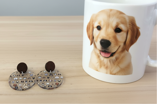 Mug with a dog photo and round earrings on a wooden surface