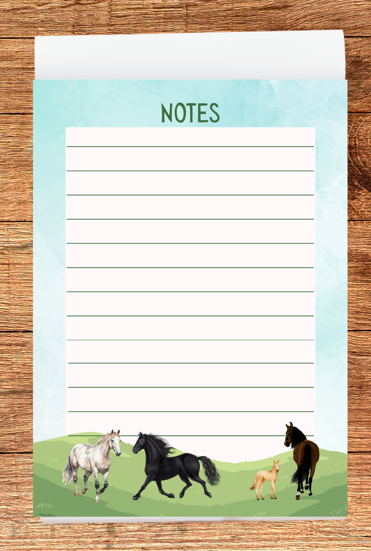 Notepad with horse illustrations on a wooden surface