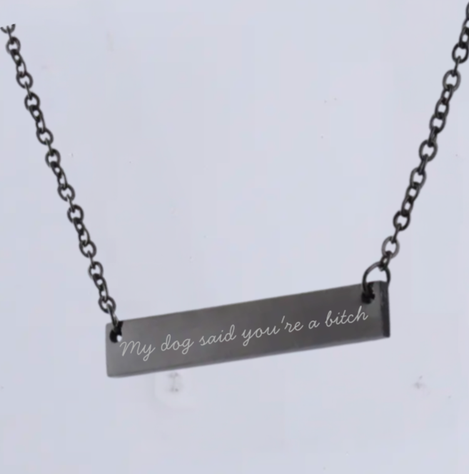 Necklace with a bar pendant that reads 'My dog said you're a bitch' on a light gray background