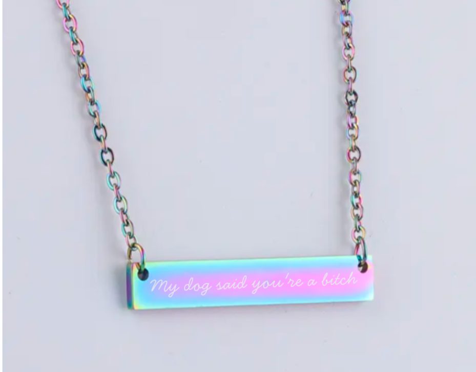 Necklace with a bar pendant displaying text on a light gray background