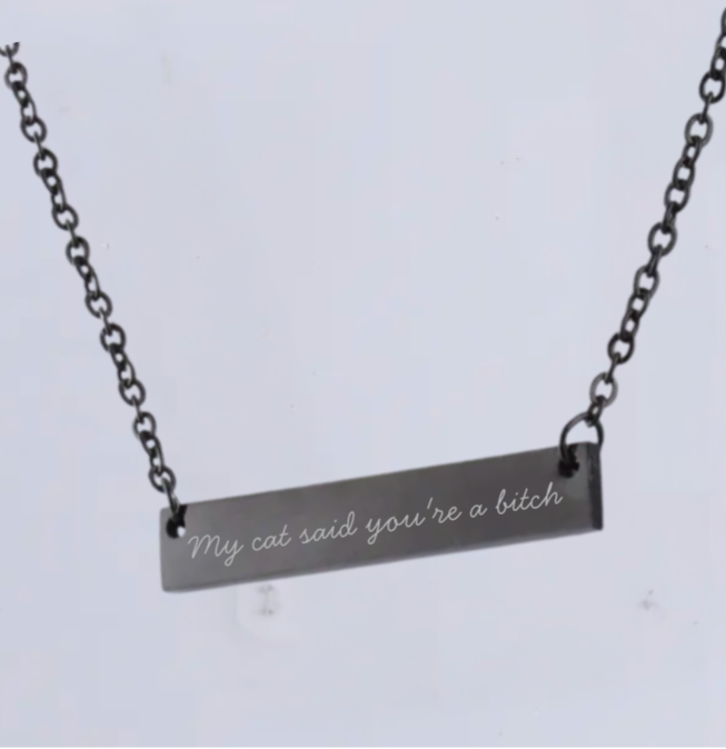 Necklace with a bar pendant featuring engraved text on a light gray background